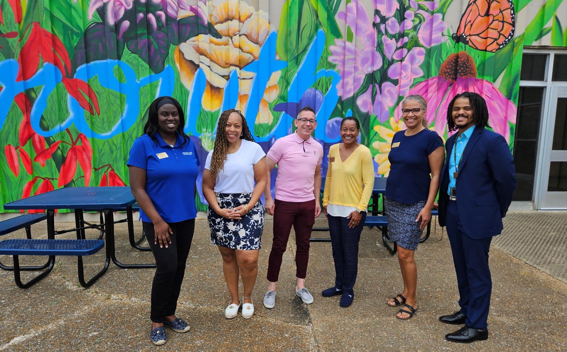 LLCC staff at standing in front of mural at Southeast High School