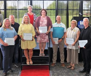 Eight members of 25-year service anniversary group