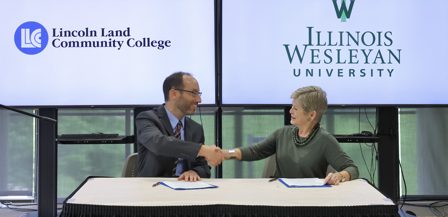 Dr. Dockter from LLCC shaking hands with Dr. Nugent from Illinois Wesleyan