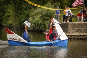 Library staff in their boat, "RV Swan Linc," winning their race.