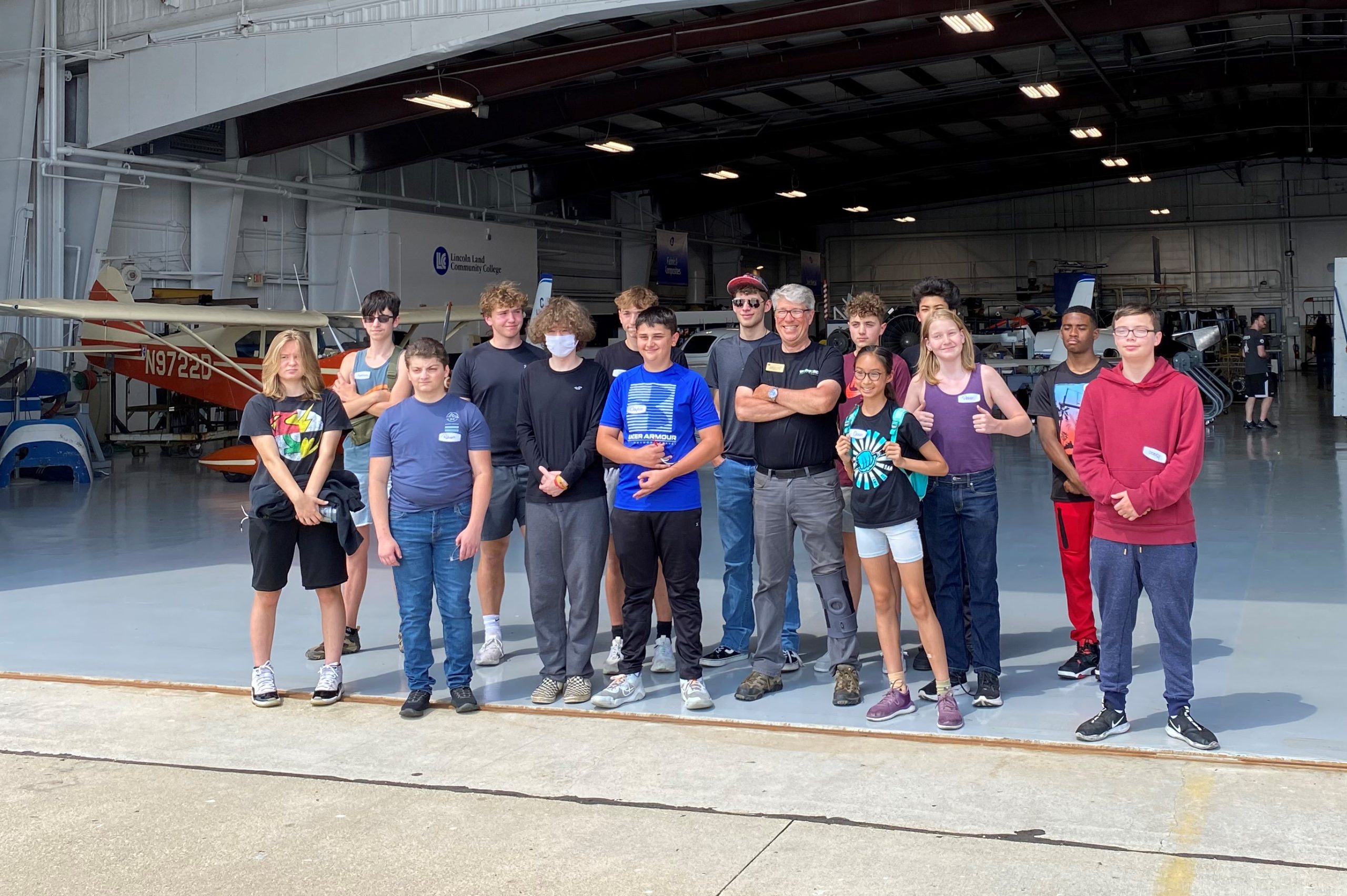 Teen Learning Lab participants pictured with Dave Pietrzak at the opening of the hangar by the tarmac