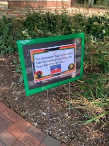 Yard sign that says: 1997. The Juneteenth flag is created by Ben Haith and collaborators. The flag is full of symbolism.