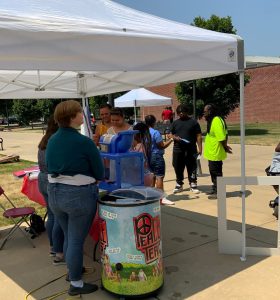 Visitors enjoying snow cones, the cookout and music