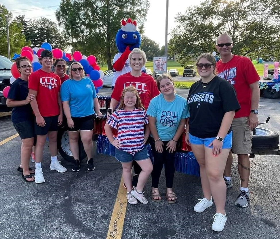Group of people in LLCC T-shirts with Linc on the parade float