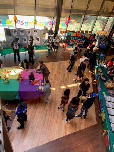 Students at tables and exhibits for Hispanic Heritage Month in A. Lincoln Commons