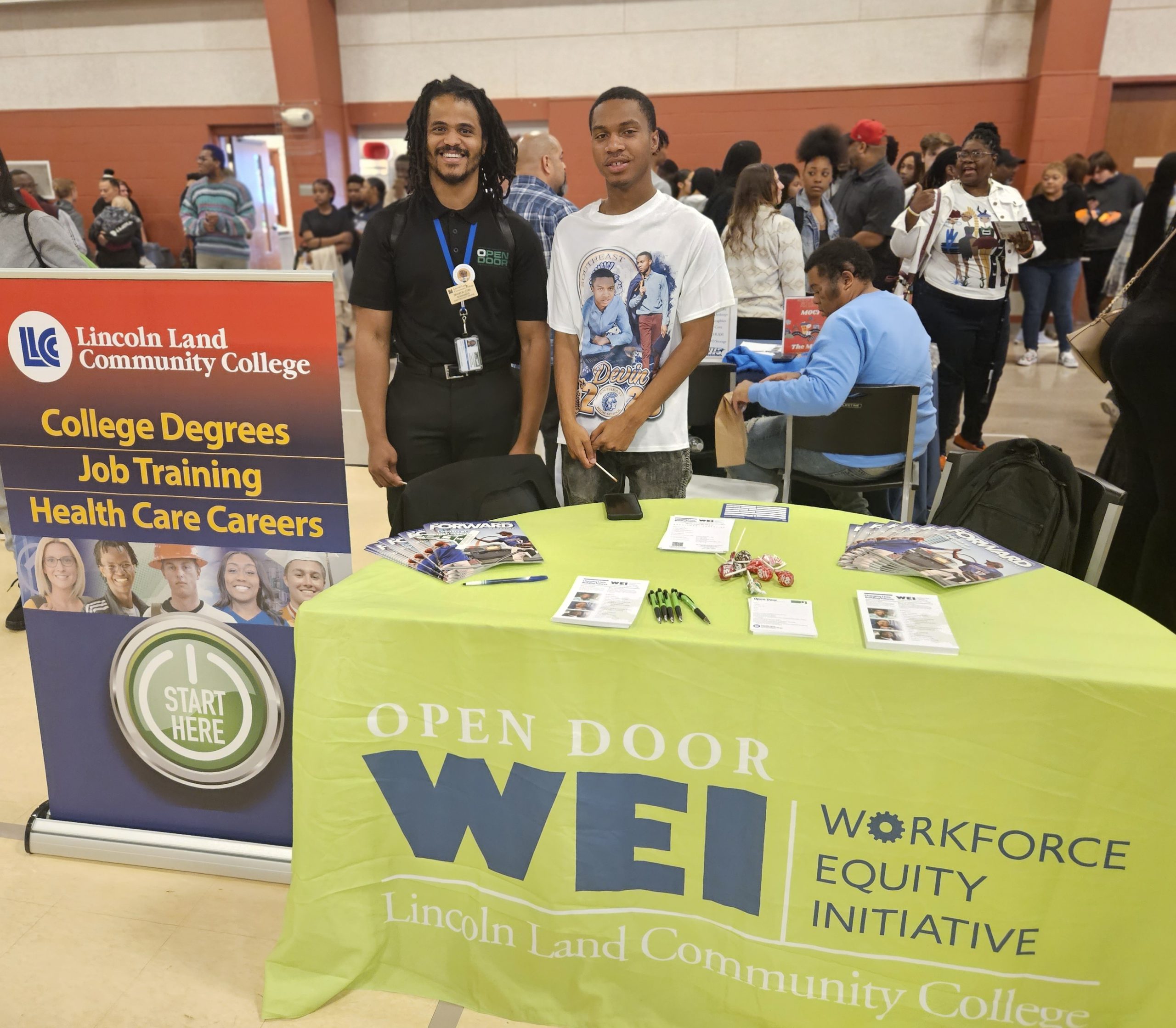 Brandon Lewis with a student at the WEI table