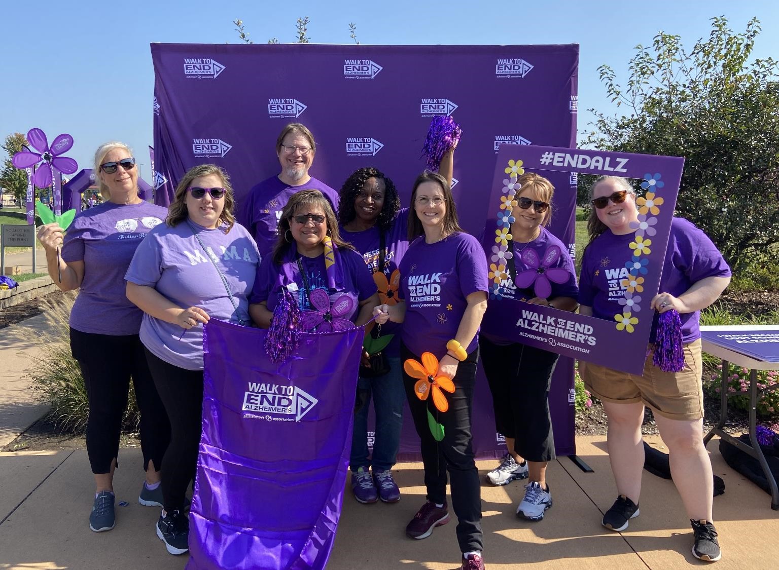 Team Loggers pose at the Walk to End Alzheimer’s photo booth. L to R: Bobbi Henry, Kassie Thompson, Kirk Yenerall, Marina Wirsing, Laurie Clemons, Leslie Johnson, Karen Sanders and Carley Young. 