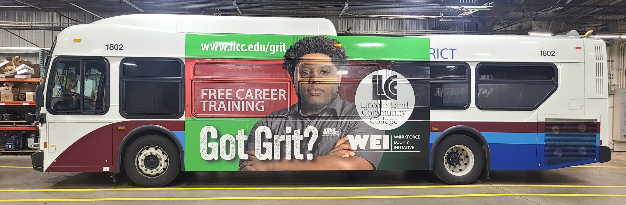 Side of bus with WEI Workforce Equity Initiative ad. www.llcc.edu/grit. Free career training. Got Grit? LLCC. Lincoln Land Community College.