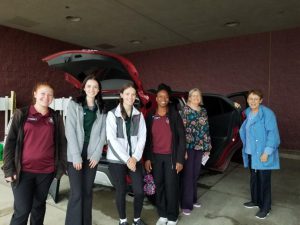 Dr. Maskey with students and volunteer and car seat clinic