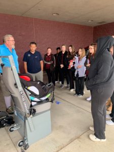 Students getting instruction on installing car seats
