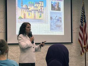Rihab Sawah speaking in front of attendees