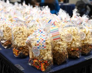 donor gift bags with popcorn, honey and other treats
