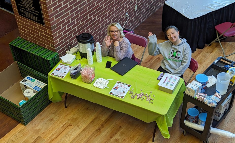 Table in A. Lincoln Commons staffed by two people to accept donations