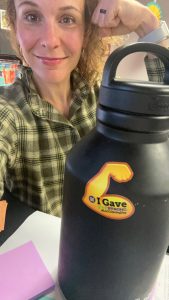 selfie photo of Michelle Burger holding cup with "I Gave" emoji sticker