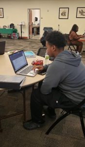 Student working on laptop at a study table