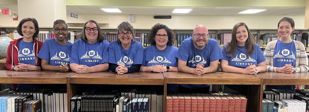 Librarians from the LLCC library stand side by side for a photo in the LLCC Library.