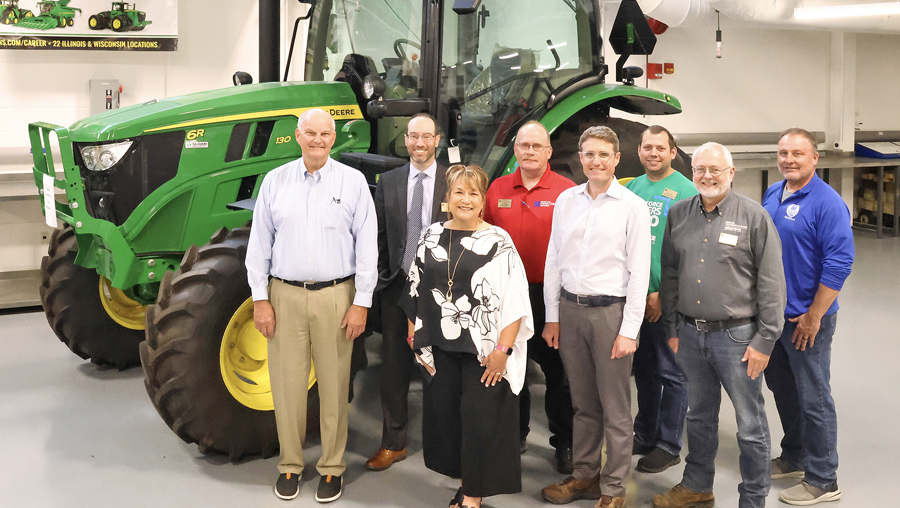 LLCC Foundation and faculty pose with Jeff Sloan by the tractor he donated to the LLCC Diesel Technologies program.