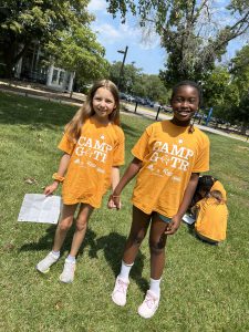 Two girls from the Girls on the Run camp, smile and pose.