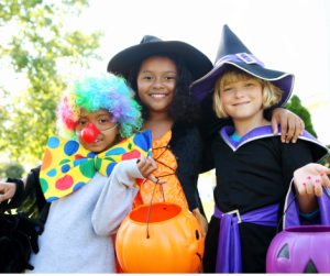 Three kids in Halloween costumes