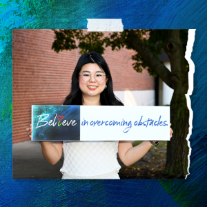 LLCC student holding a sign reading Believe in overcoming obstacles.