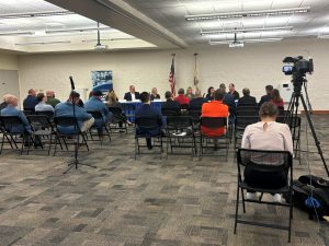 People sitting in chairs listening to a panel discussion on career and technical education.