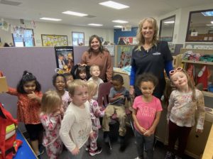 Preschool children posing with dental instructors after receiving a teeth cleaning.