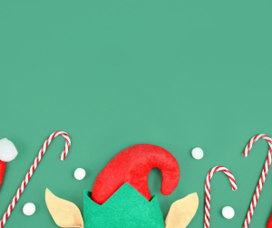 Elf hat and candy canes on a green background.