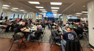 LLCC faculty and staff seated at tables in the Student Union.