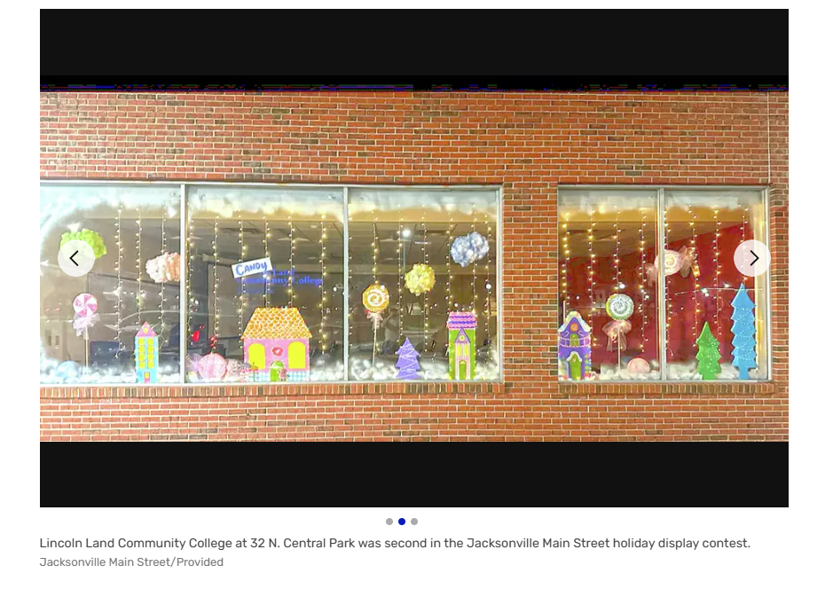 photo of the front windows at LLCC Jacksonville, decorated with various candy land themed Christmas decor. The sign out front says "Candy Land Community College".