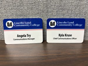 Blue and white LLCC nametags that read, Angela Try, communications manager and Kyla Kruse, chief communications officer