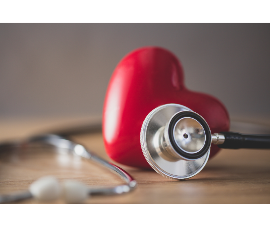 Stethescope lying next to a plastic red heart for heart health month.